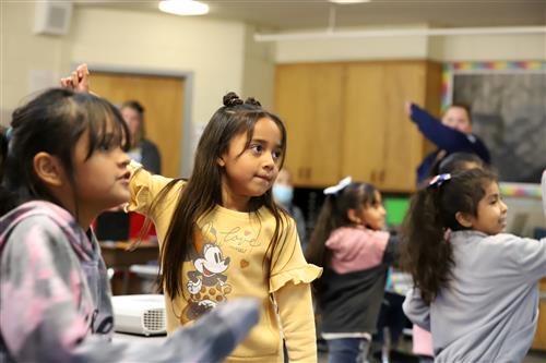 Howard Elementary students dancing in a classroom